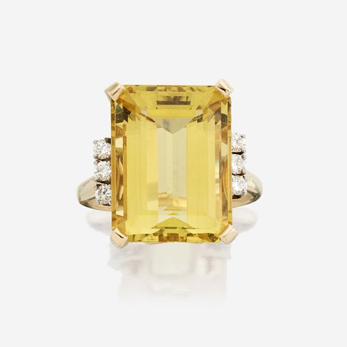 A yellow beryl, diamond, and fourteen karat gold ring