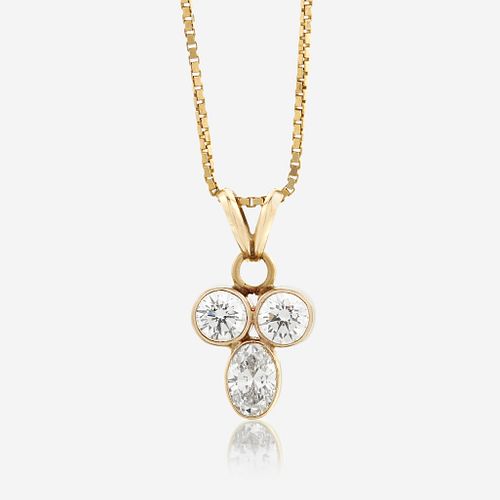 A diamond and fourteen karat gold pendant