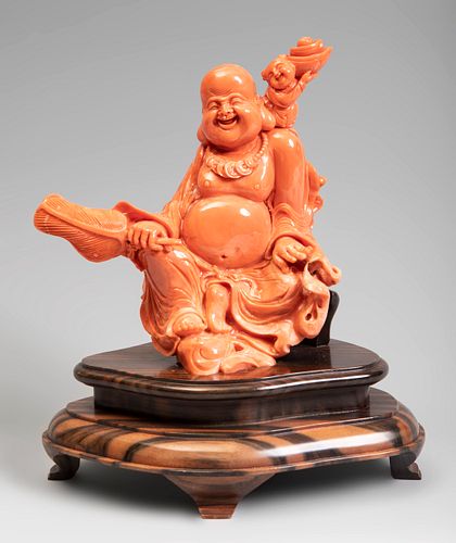 Smiling Buddha. China, 20th century.
Coral.
Wood base.