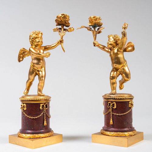 Pair of Continental Gilt-Bronze and Marble Putti Candlesticks