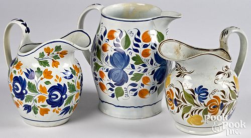 Three pearlware pitchers, 19th c., with floral dec