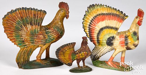 Three carved and painted roosters, late 19th c.