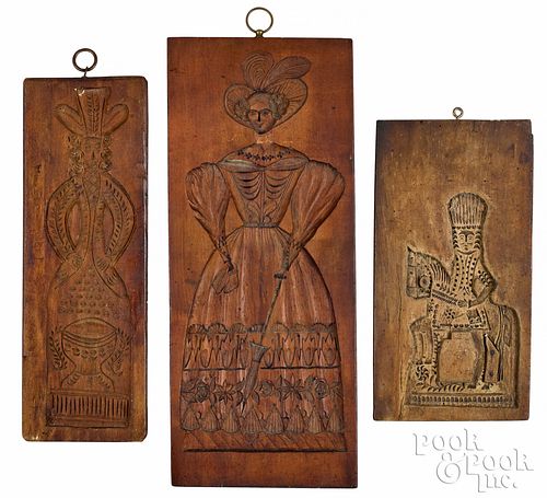 Three carved cakeboards, 19th c., with figural dec