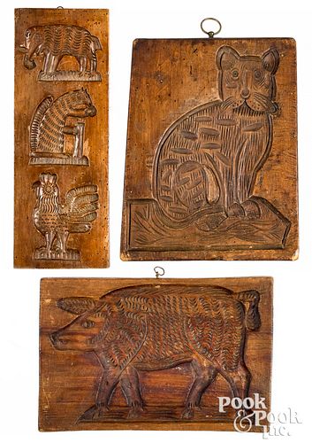 Three carved cakeboards, 19th c., to include a cat