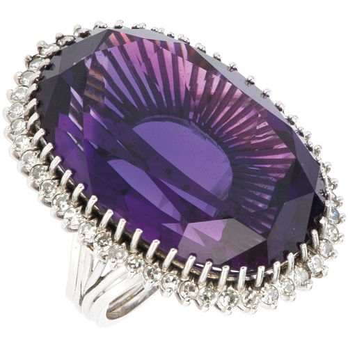 RING WITH AMETHYST AND DIAMONDS IN PLATINUM Oval cut amethyst ~40.0 ct, 8x8 cut diamonds ~1.0 ct. Weight: 22.5 g. Size: 6