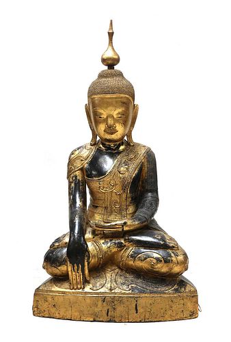 A large South-East Asian wooden and lacquered Shakyamuni buddha,