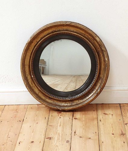 A Regency gilt-framed convex wall mirror,