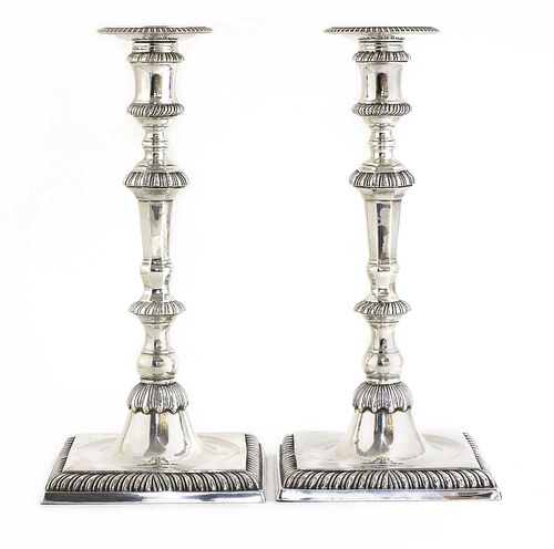 A pair of cast silver candlesticks,
