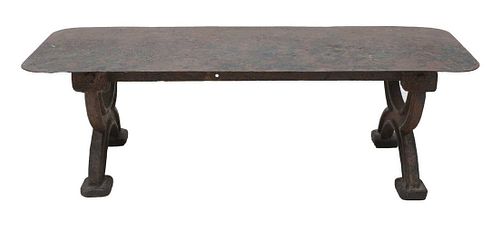 An industrial cast and sheet iron coffee table,