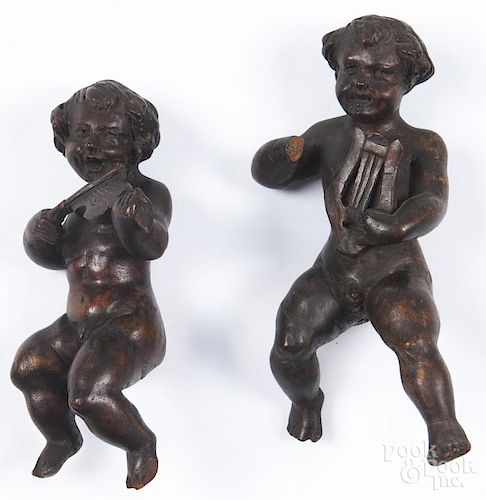 Two Continental carved walnut putti, 18th c., 8 1/2'' h. and 9 1/2'' h. Provenance: DeHoogh Gallery