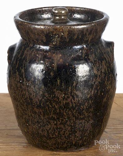 Stoneware covered jar, 20th c., unmarked with mottled glaze, 7'' h. Provenance: DeHoogh Gallery