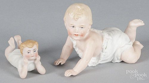 Three German bisque piano babies, 19th c., two Gebruder Heubach, 4 1/2'' l. and 5'' l.
