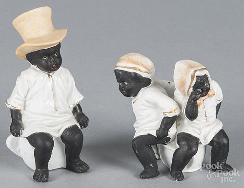 Two Black Americana bisque figures of children sitting on a chamber pot, late 19th c., 4 1/4'' h.