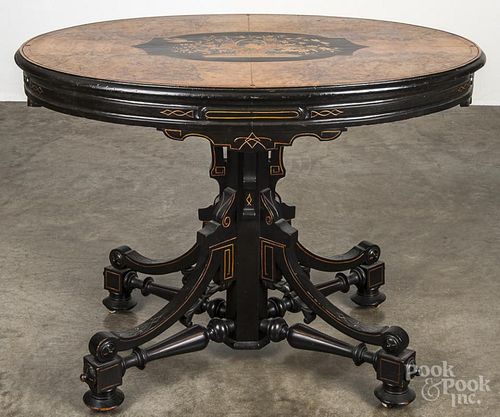 Aesthetic style burl veneer and ebonized center table, mid 20th c., with a marquetry inlaid top