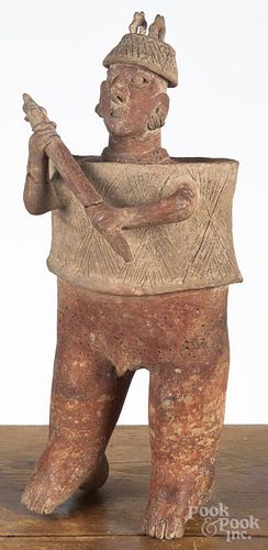 Pre-Columbian pottery standing warrior figure, Nayarit or Jalisco, with a helmet, armor, and a club