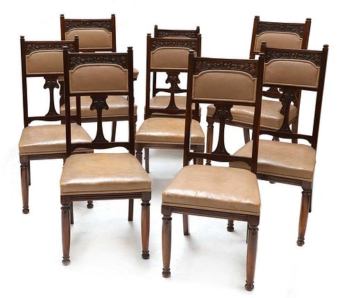A set of eight Art Nouveau walnut dining chairs,
