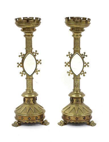 A pair of Gothic Revival brass candlesticks,