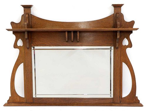 An Arts and Crafts oak overmantel mirror,