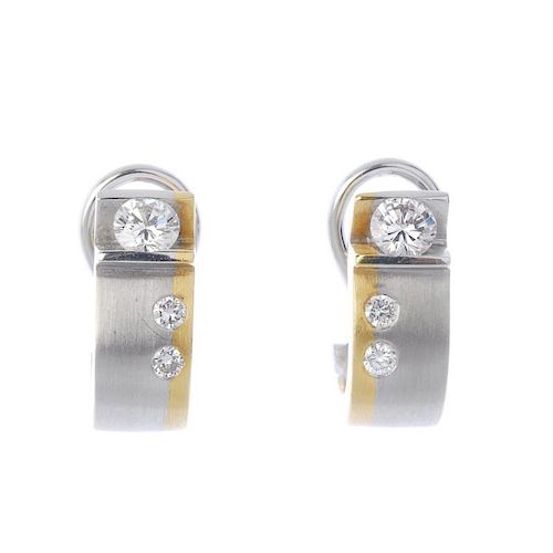 A pair of 18ct gold diamond ear hoops. Each of bi-colour design, comprising a tension-set brilliant-