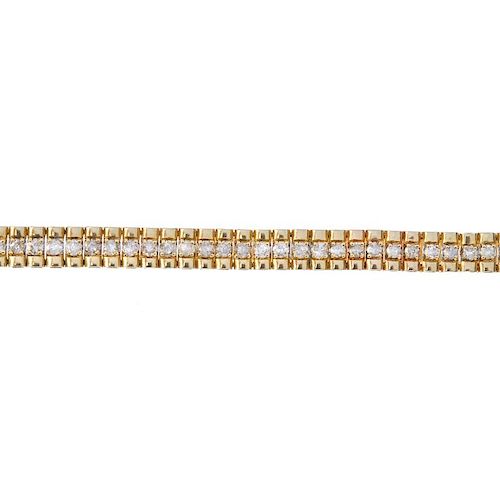 A 9ct gold diamond bracelet. Of bi-colour design, the brilliant-cut diamond line, to the polished si