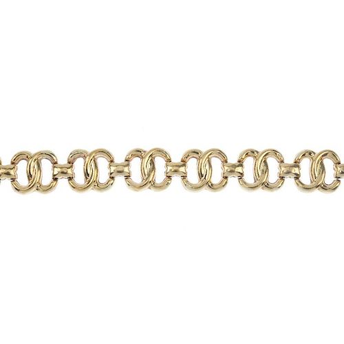 A 9ct gold bracelet. Designed as a series of interwoven oval-shape links, with plain bar spacers, to