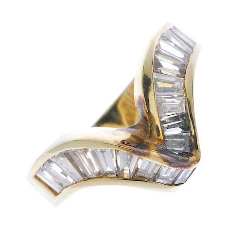 A diamond chevron ring. The tapered baguette-cut diamond curved lines, to the slightly tapered band.