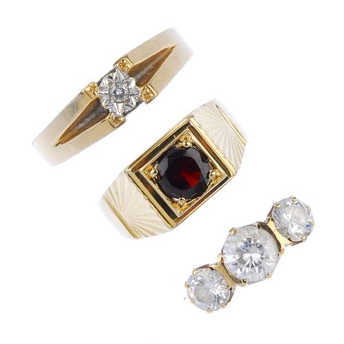 A selection of seven rings. To include a 9ct gold garnet single-stone signet ring, a gentleman's 9ct