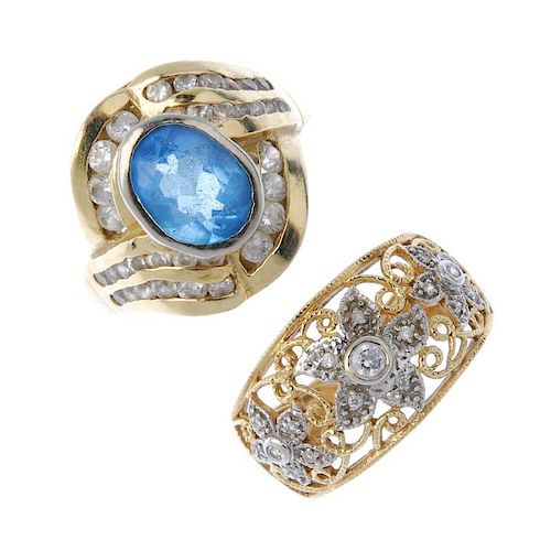 Two gem-set dress rings. To include a 14ct gold cubic zirconia openwork floral band ring and a blue