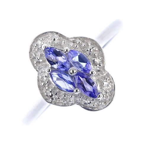 A 9ct gold tanzanite and diamond cluster ring. The marquise-shape tanzanite cluster, within a single