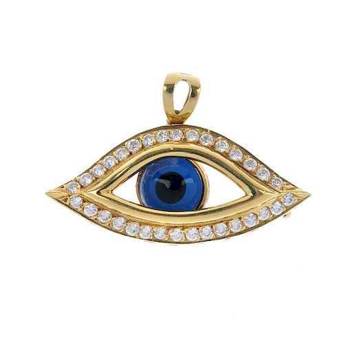 An 18ct gold cubic zirconia eye pendant. Designed as a glass eye, to the cubic zirconia surround, wi