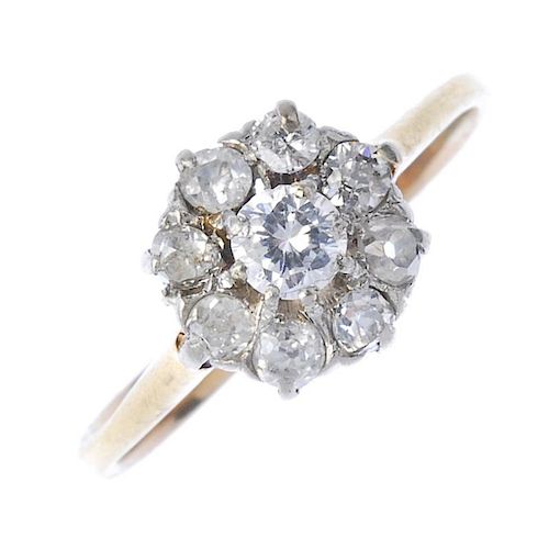 A mid 20th century gold diamond ring. The brilliant-cut diamond, within an old-cut diamond surround,