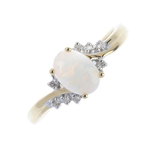 A 9ct gold opal and diamond dress ring. The oval opal cabochon, to the single-cut diamond asymmetric