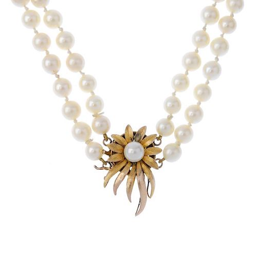 A cultured pearl two-row necklace, with floral spray clasp. The cultured pearls, measuring 6mms, to