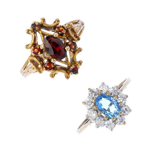 A selection of four 9ct gold gem-set rings. To include a garnet five-stone ring, a blue topaz and cu