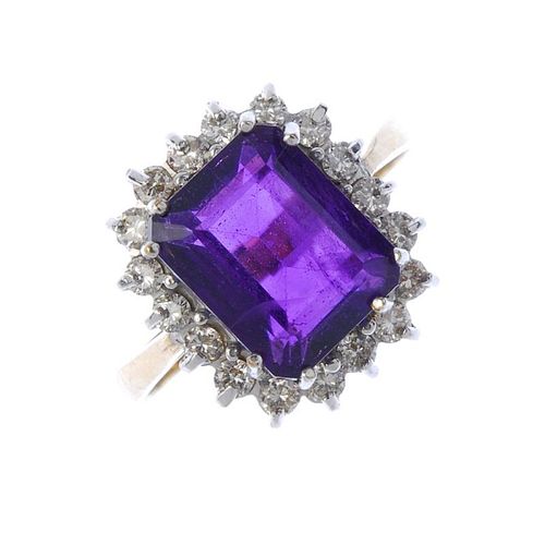 A 9ct gold amethyst and diamond cluster ring. The square-shape amethyst within a brilliant-cut diamo