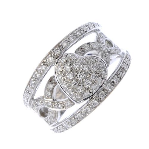 A diamond dress ring. Designed as a brilliant-cut diamond heart-shape panel, to the similarly-cut di