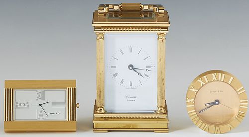 Group of Three Gilt Bronze Clocks, 20th c., consisting of an English carriage Clock by Comitti, London; a Tiffany & Co. folding easel travel clock, an