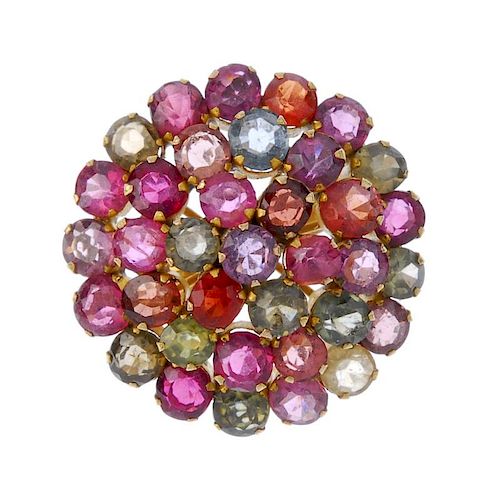 A multi-gem cluster ring. Designed as a circular-shape multi-gem, stepped cluster to the plain band.