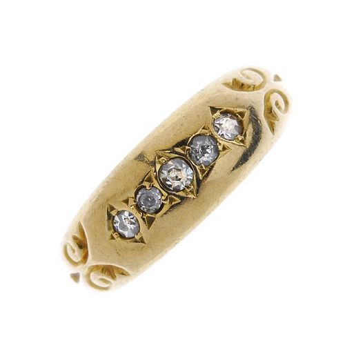 An early 20th century 18ct gold diamond five-stone ring. The single-cut diamond line, with scrolling