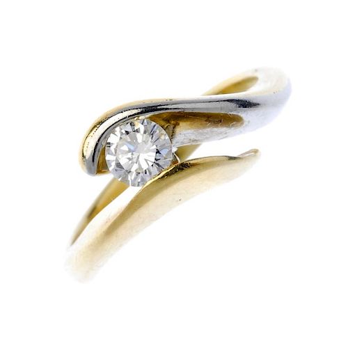 A diamond crossover ring. Of bi-colour design, the brilliant-cut diamond, to the asymmetric shoulder