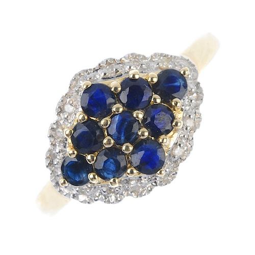 A 9ct gold sapphire and diamond cluster ring. The circular-shape sapphire lozenge-shape cluster, wit