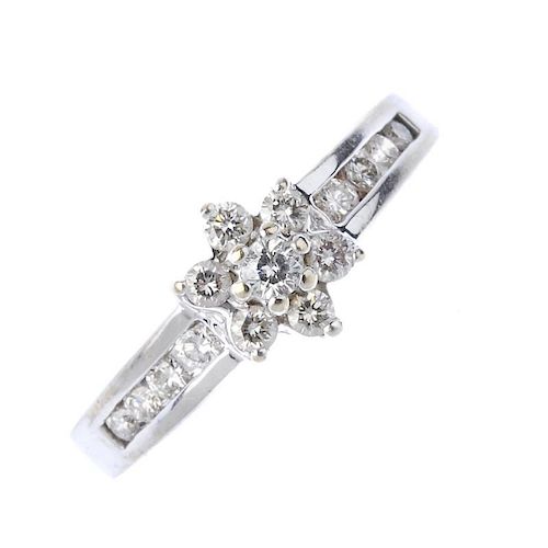 An 18ct gold diamond cluster ring. Of floral design, the brilliant-cut diamond cluster, to the simil