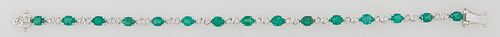 18K White Gold Link Bracelet, each of the fifteen oval links mounted with an oval emerald, joined by two small diamond mounted links, total emerald wt