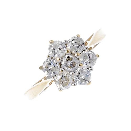 An 18ct gold diamond floral cluster ring. The brilliant-cut diamond, within a similarly-cut diamond