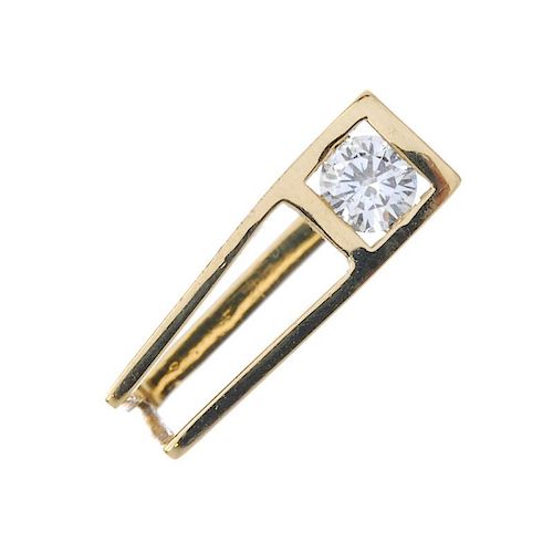 An 18ct gold diamond single-stone ring. Of geometric design, the brilliant-cut diamond, to the taper