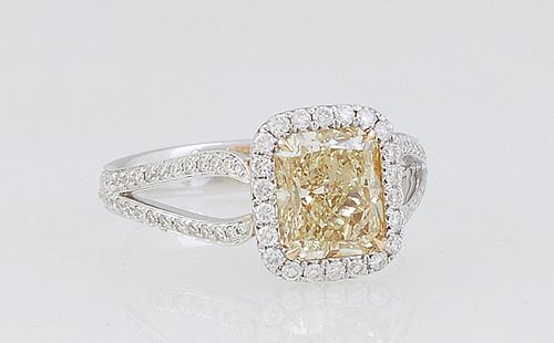 Lady's 18K White Gold Dinner Ring, with a 2 carat rectangular yellow diamond, atop a conforming border of tiny round diamonds, flanked by split diamon
