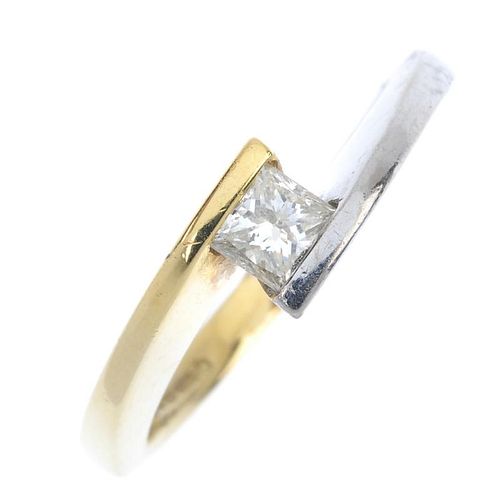 An 18ct gold diamond crossover ring. Of bi-colour design, the square-shape diamond, to the asymmetri