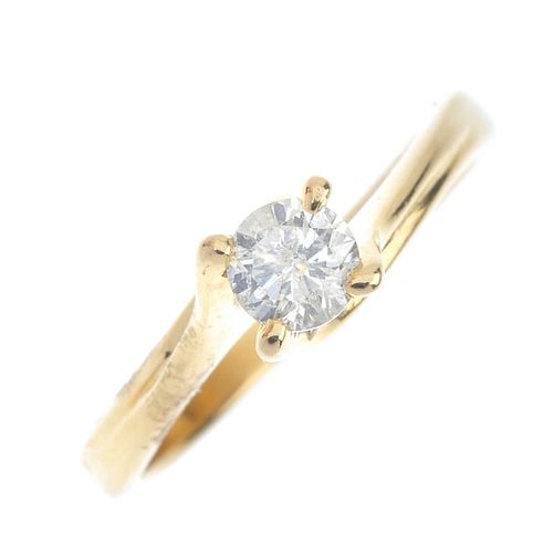 An 18ct gold diamond single-stone ring. The brilliant-cut diamond, to the spiral gallery and asymmet