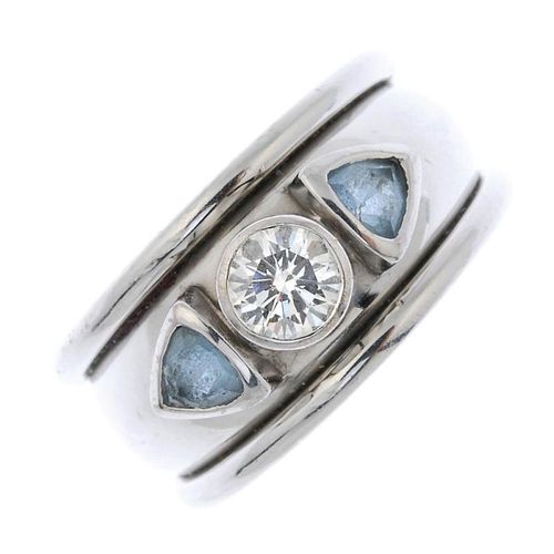 An 18ct gold diamond and aquamarine ring. The brilliant-cut diamond collet, between triangular-shape