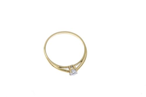 An 18ct gold diamond single-stone ring. The old-cut diamond, to the plain band. Estimated diamond we